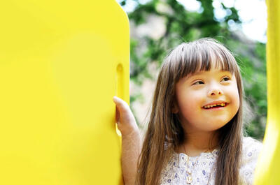 girl on yellow playground equipment