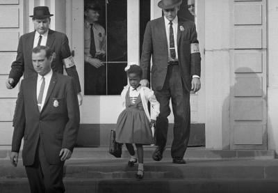 Ruby Bridges walks down the stairs of the schoolhouse